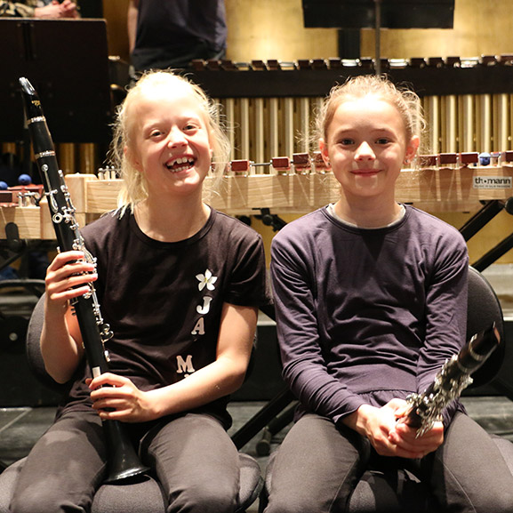 Two girls holding instruments